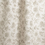 Draped fabric in watercolor floral pattern with grey-green leaves and flowers on a cream background