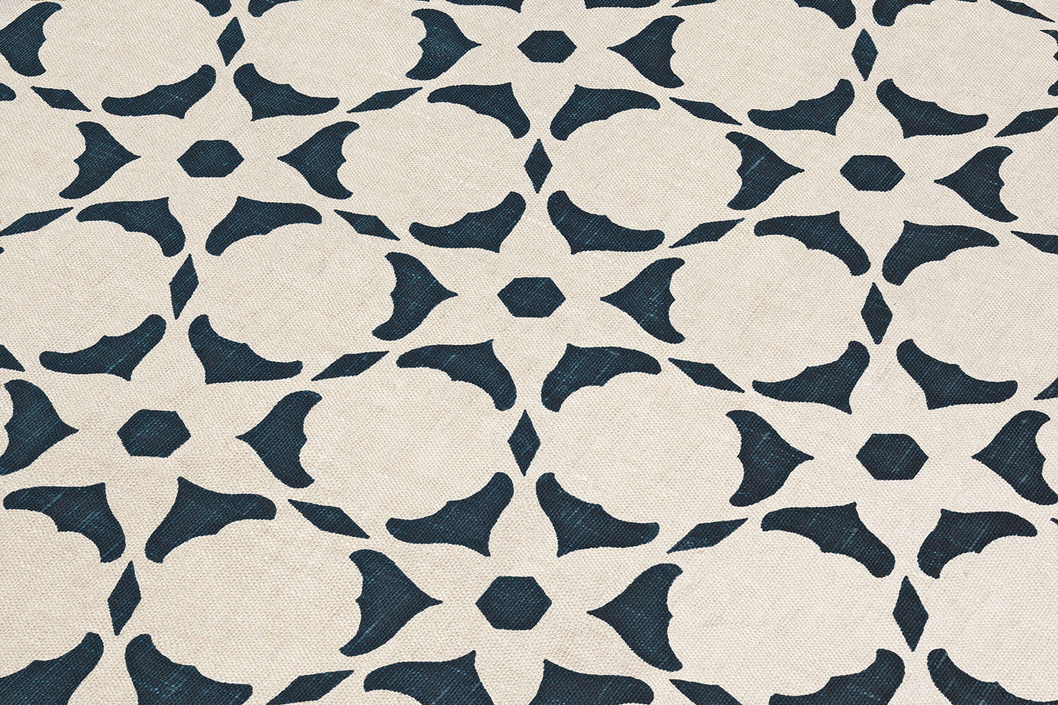 Fabric yardage in a floral lattice print in navy on a cream field.