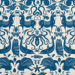 Patterned fabric with animals and sea creatures in blue on a white background