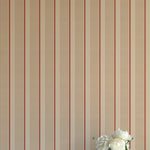 Striped wallpaper with a vase of flowers in the corner