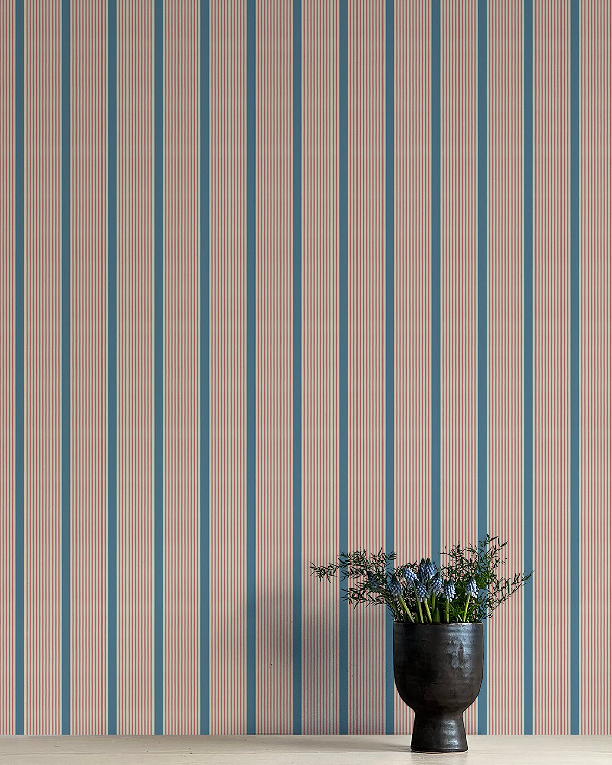 Wallpaper with vertical stripes in brown and blue on a plain background
