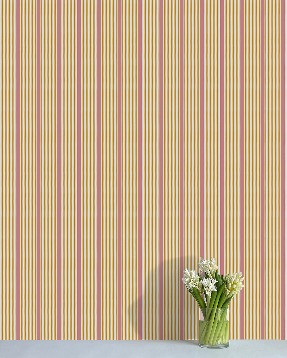 Striped wallpaper with a vase of flowers on a flat surface