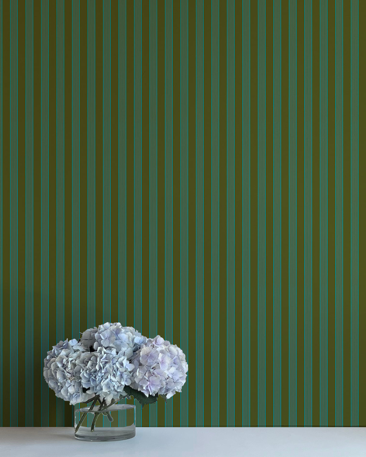 Striped green wallpaper with a vase of flowers in the foreground
