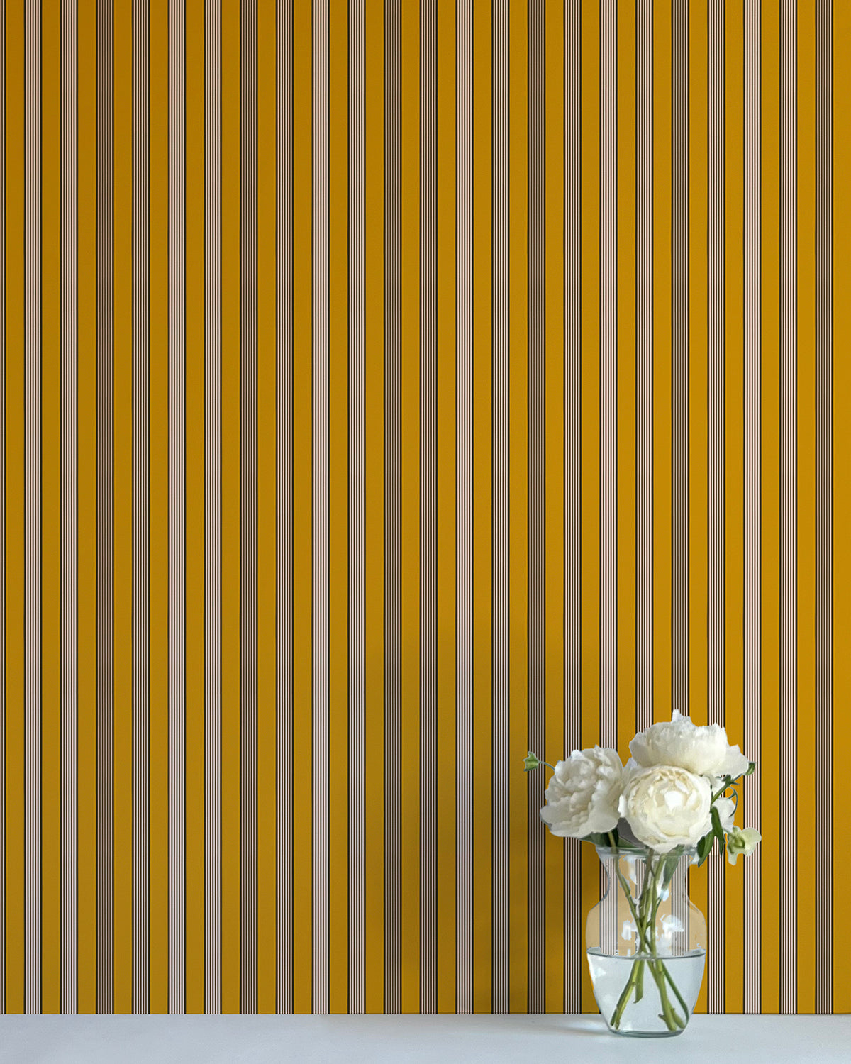Striped wallpaper with a vase of flowers on a flat surface