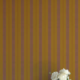 Striped wallpaper with a vase of flowers in the foreground