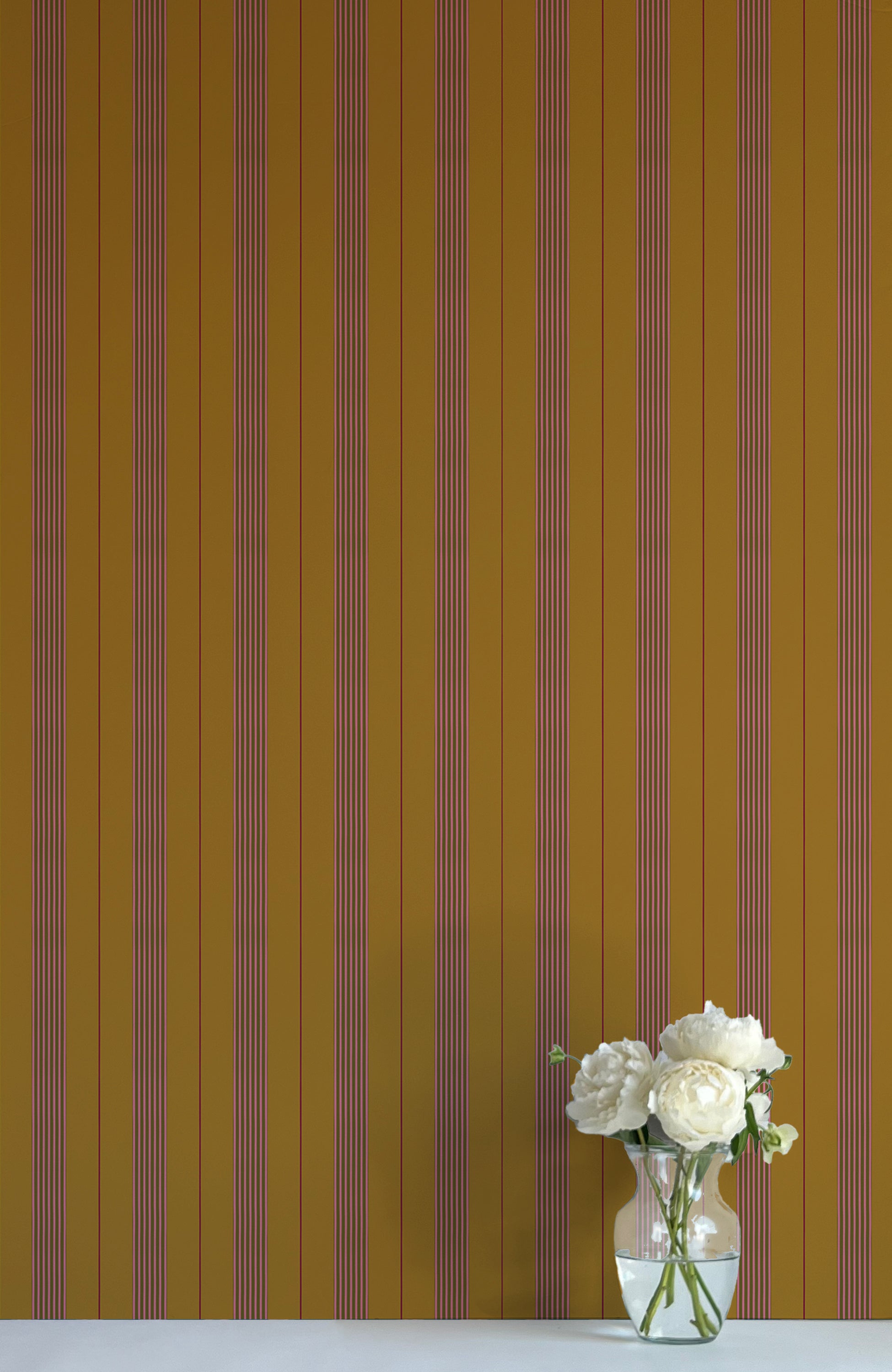 Striped wallpaper with a vase of flowers in the foreground