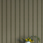 Striped wallpaper with a vase of flowers on a white surface