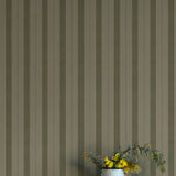 Striped wallpaper with a vase of flowers on a white surface