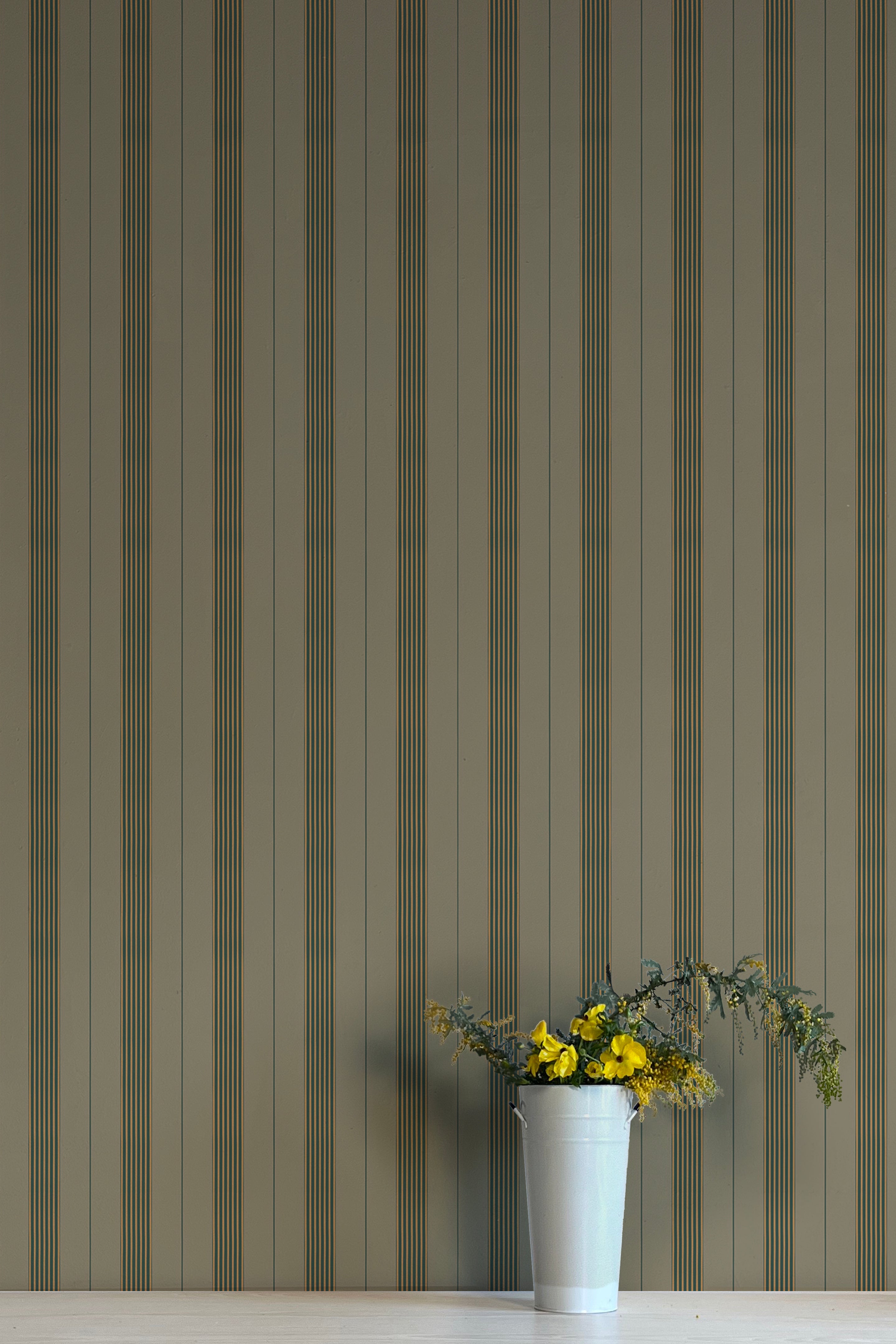 Striped wallpaper with a vase of flowers on a white surface