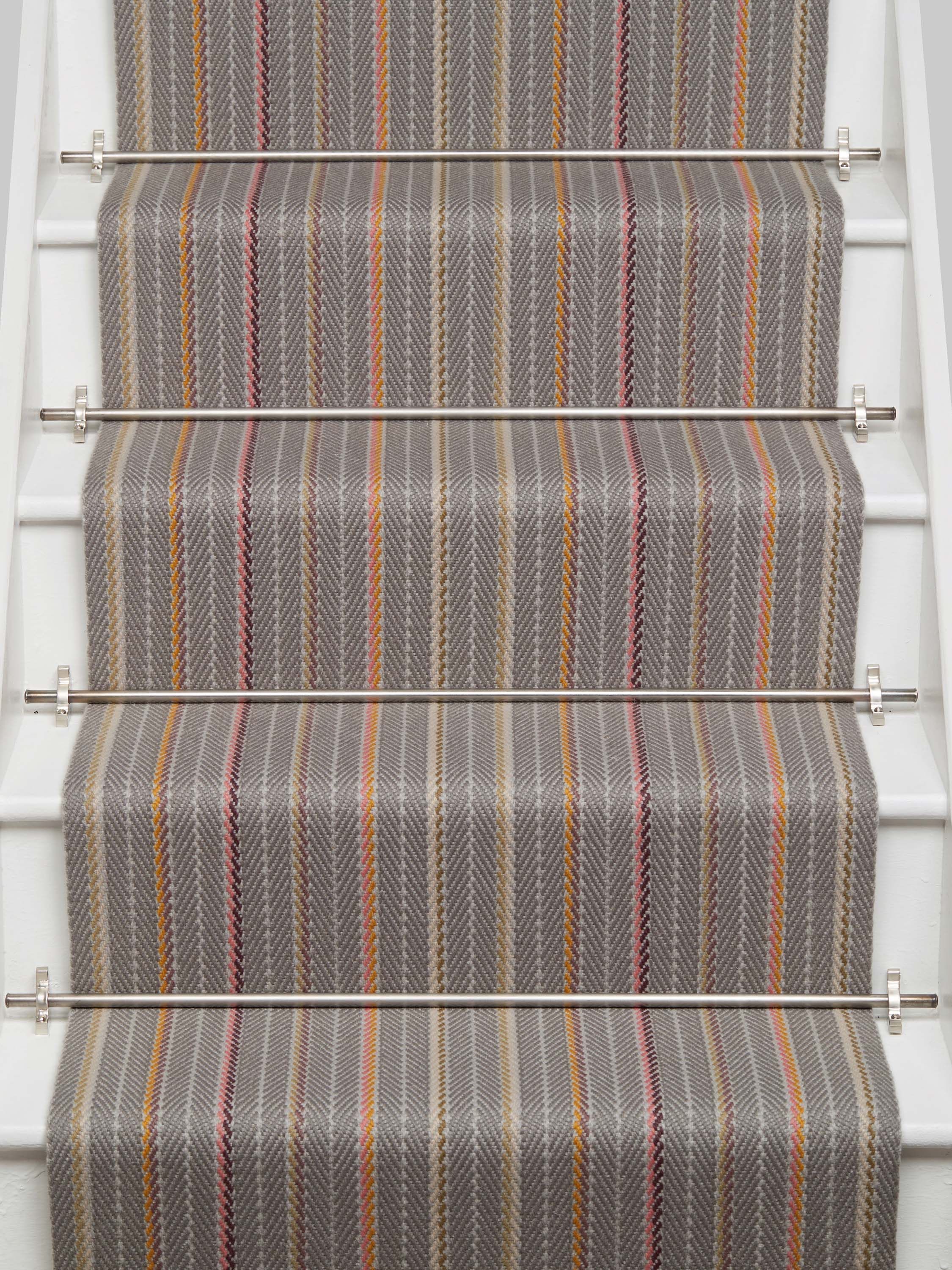 Striped flatweave runner in grey pink orange on white staircase