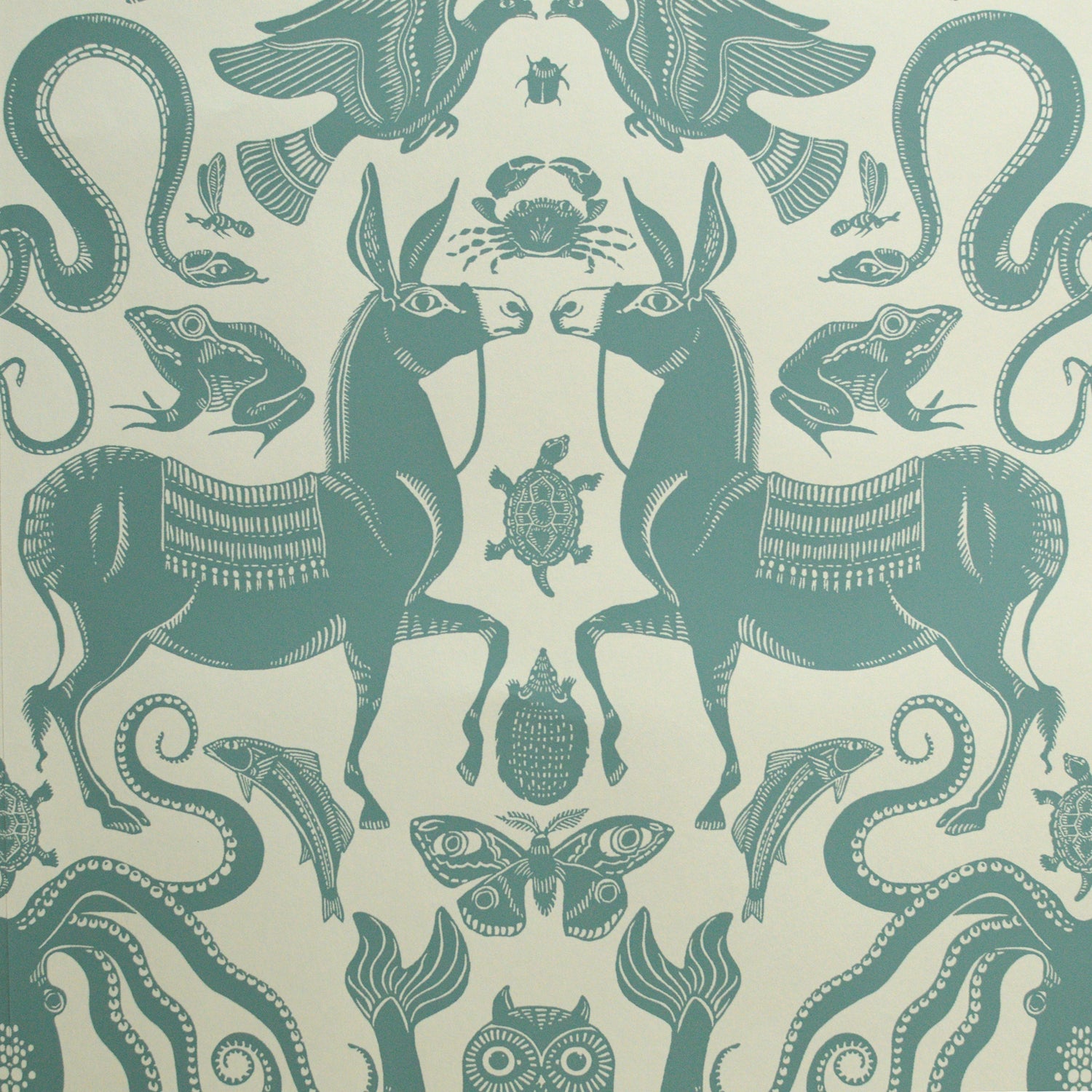 Teal animal and nature-themed pattern on a beige background