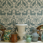 Collection of vintage ceramic items against a patterned wallpaper background