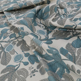 Floral patterned fabric with blue and gray leaves on a white background