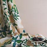 Floral-patterned fabric with figs on a neutral background