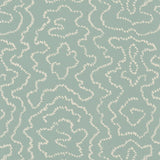 Detail of wallpaper in a minimalist wood grain print in cream on a light turquoise field.