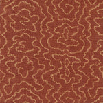 Detail of fabric in a minimalist wood grain print in tan on a rust field.