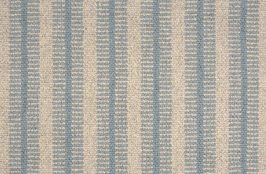 Broadloom carpet swatch in a striped pattern in a light blue neutral design