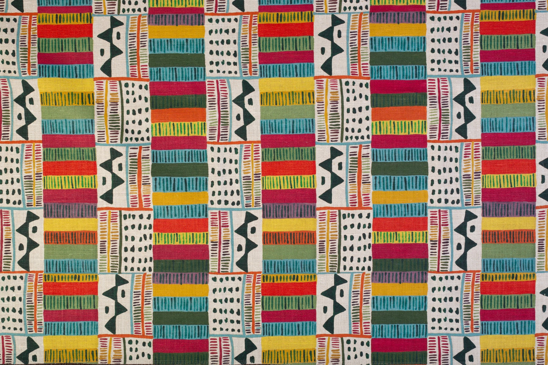 Detail of fabric in a playful geometric grid print in black, white and multicolor.