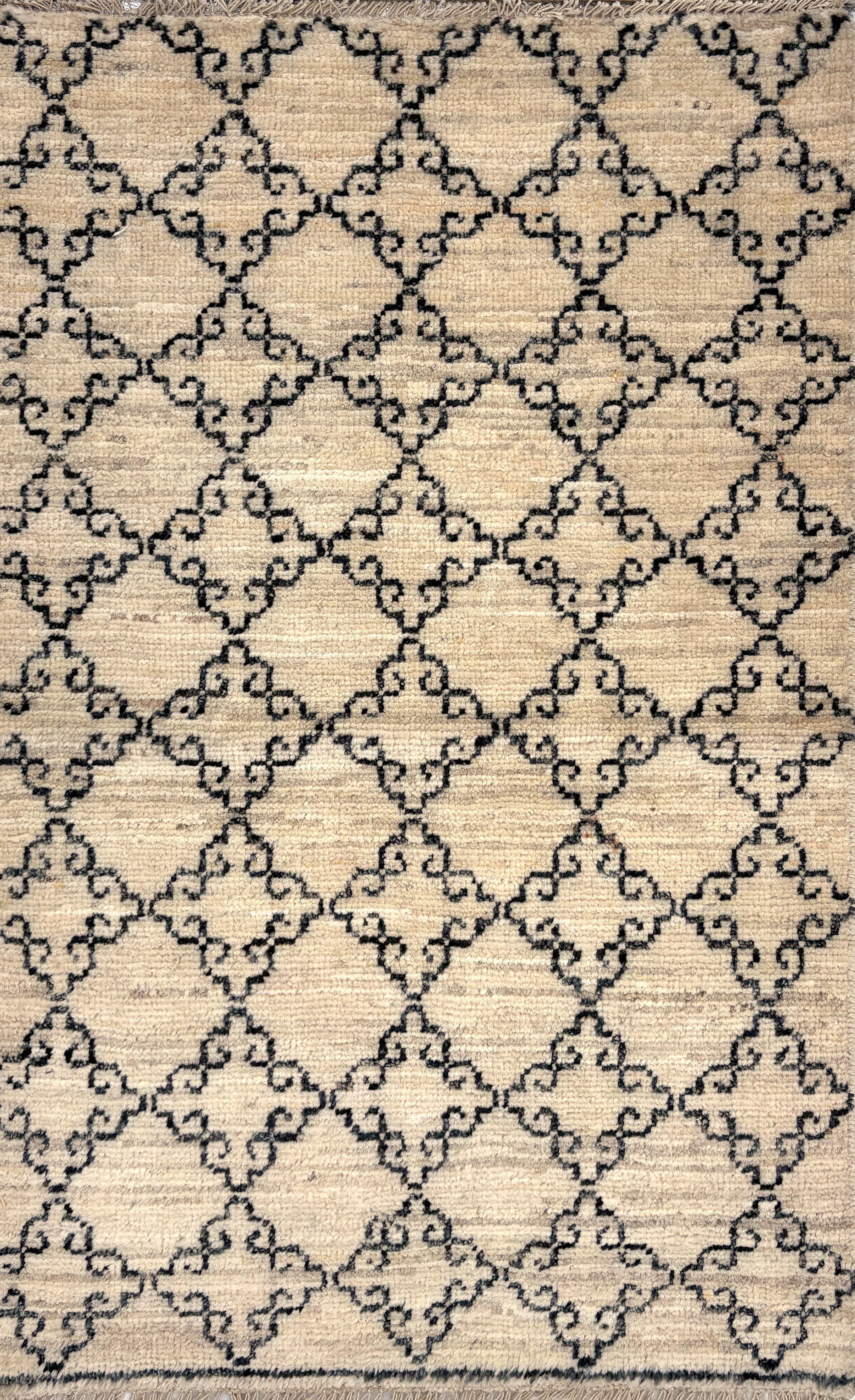Patterned rug with geometric design on a beige background