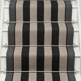 Striped flatweave runner in black and white on white staircase