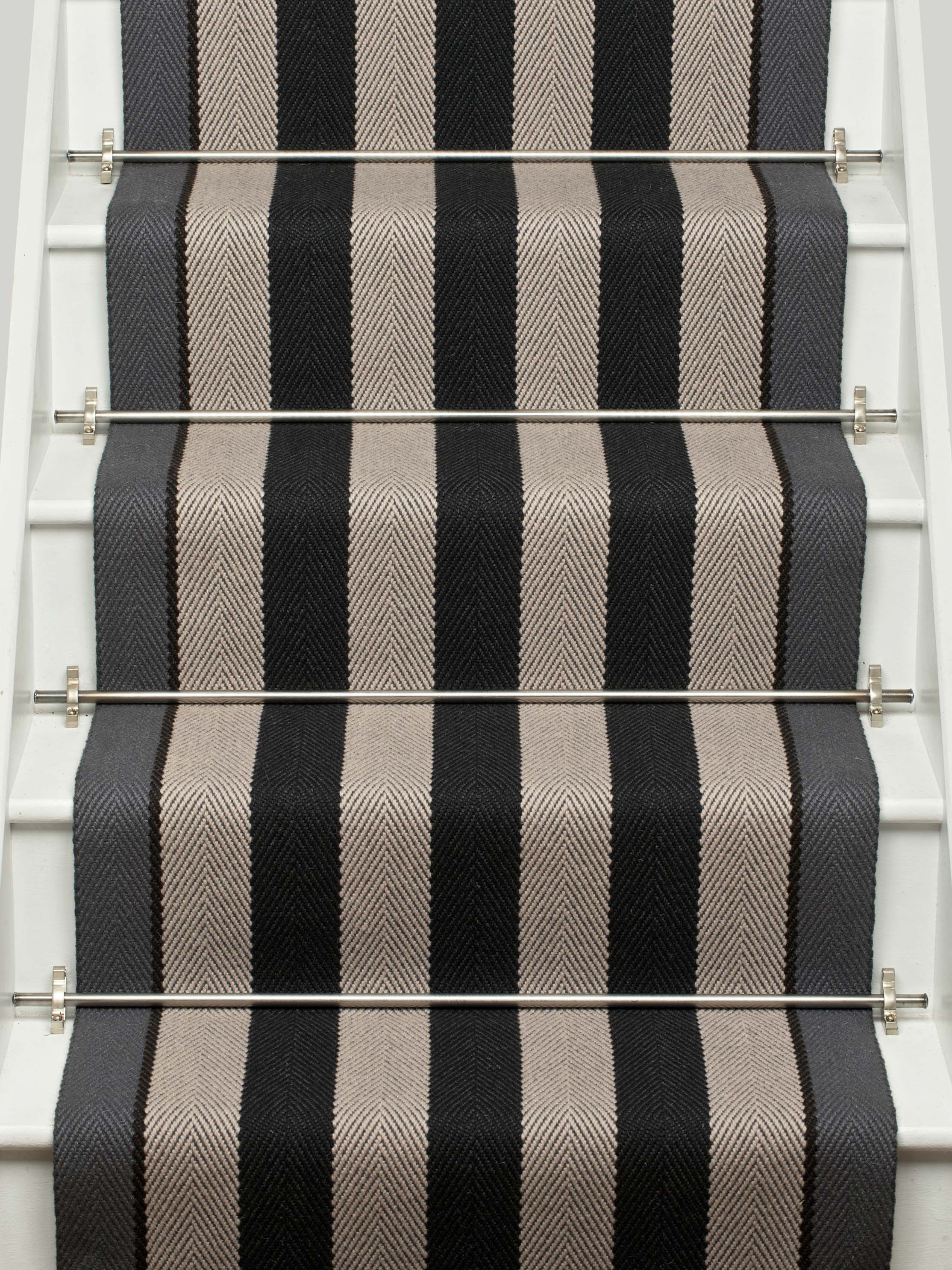 Striped flatweave runner in black and white on white staircase