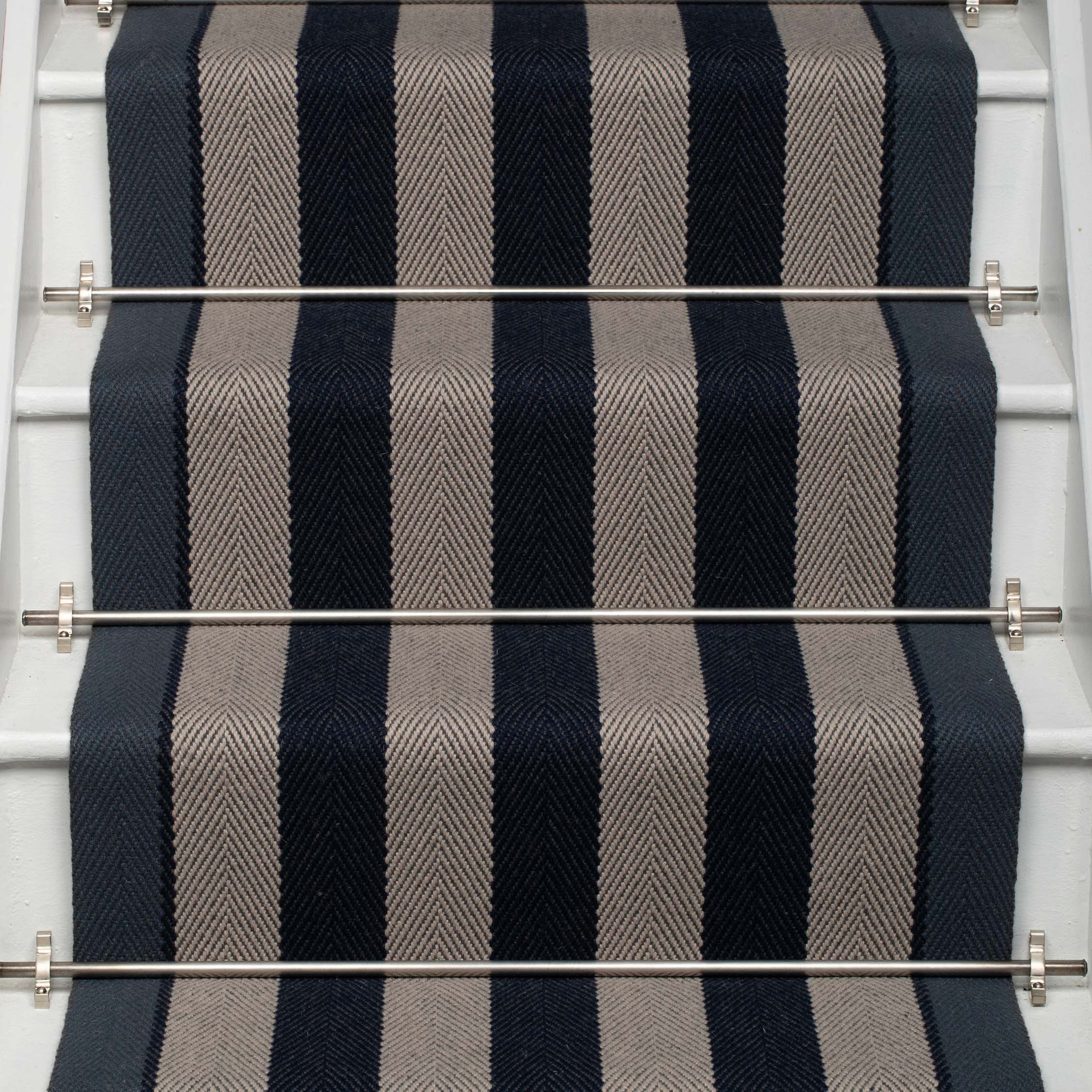 Striped flatweave runner in dark blue and grey on white staircase