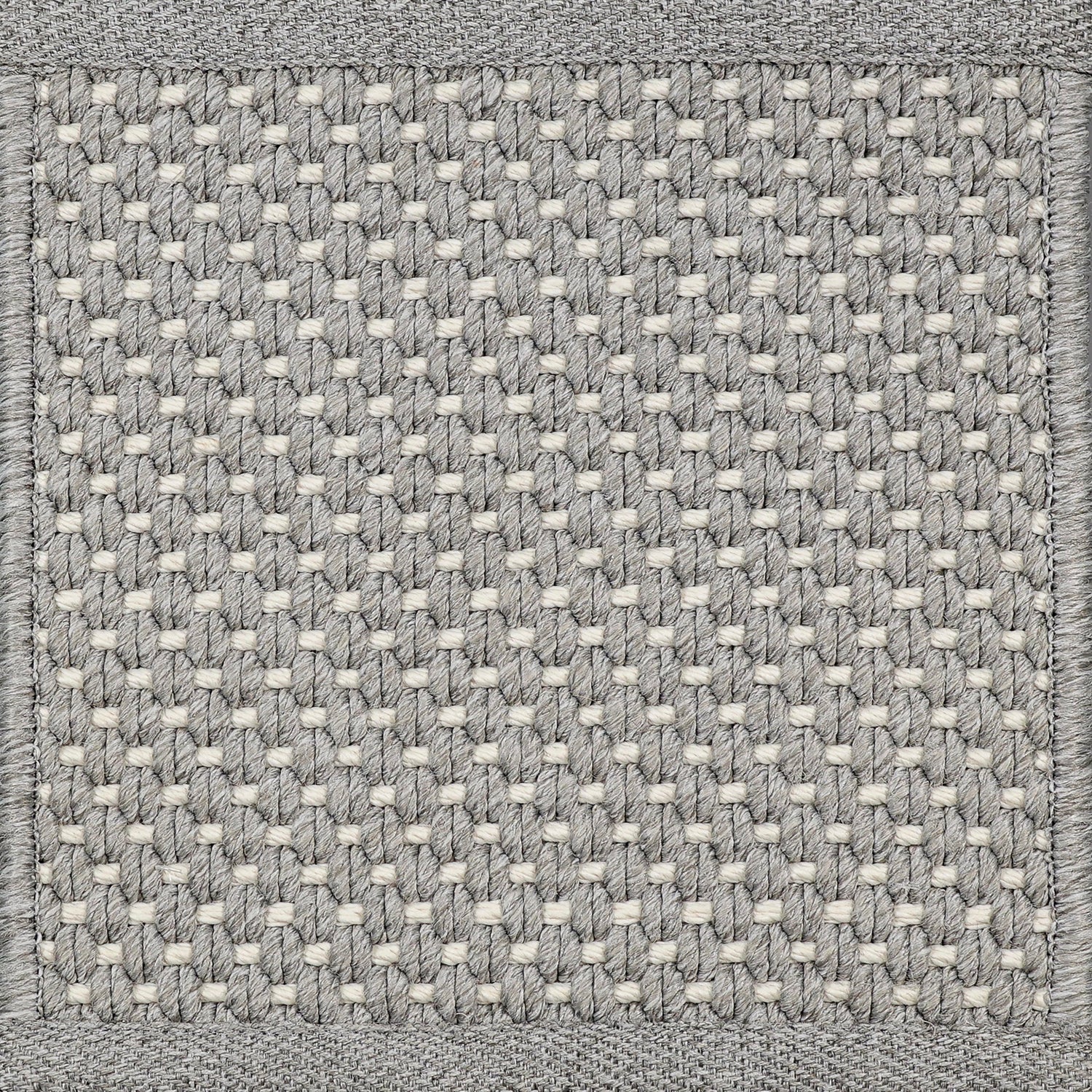 Close-up of woven carpet with a grid pattern in gray and white.