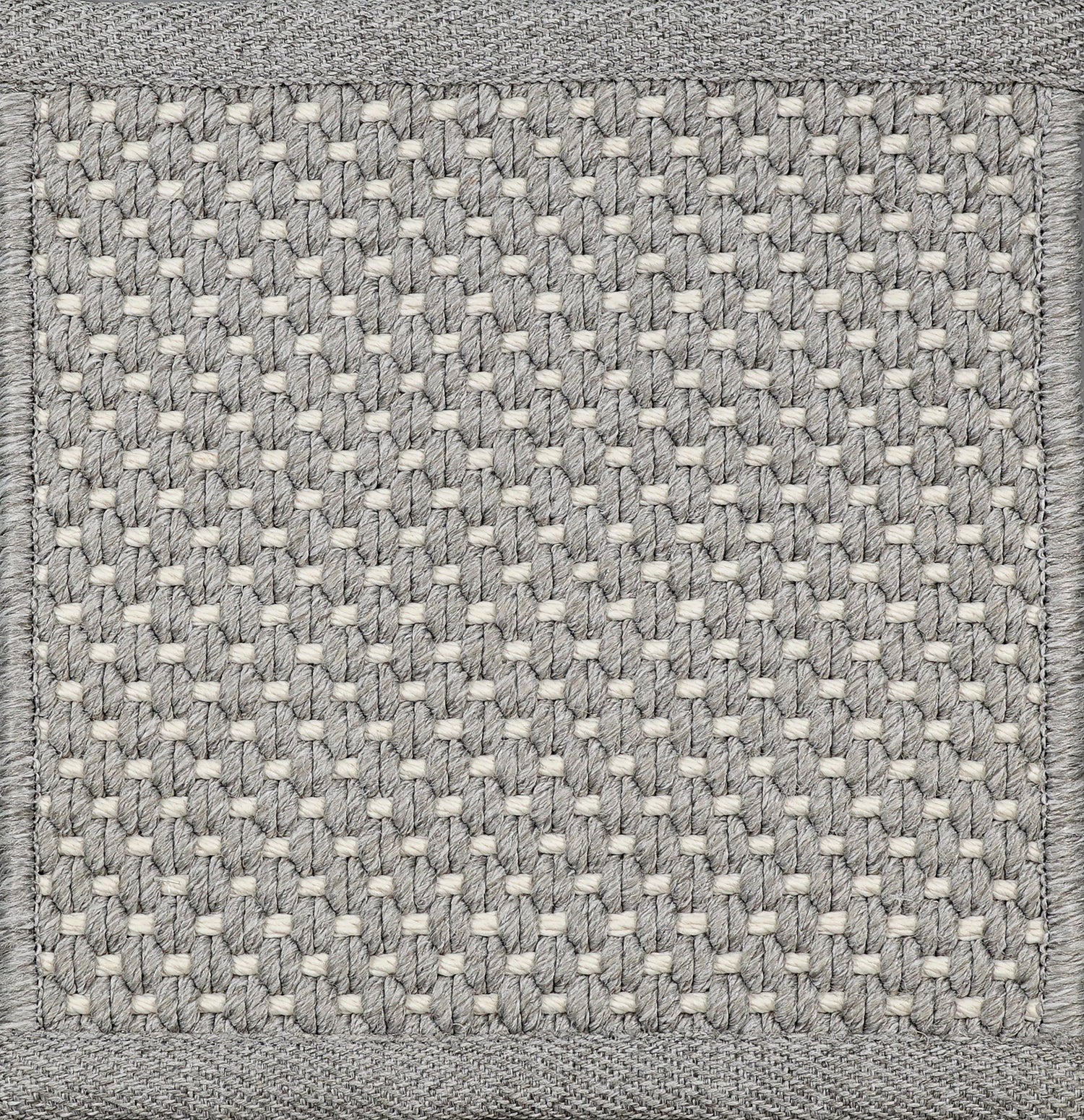 Close-up of woven carpet with a grid pattern in gray and white.