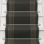 Striped flatweave runner in dark grey and white and black on white staircase