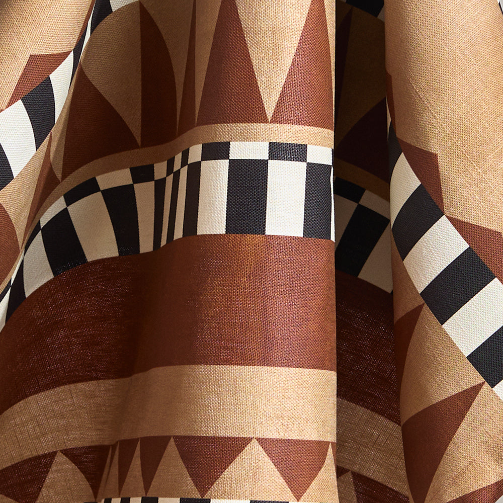 Draped bold geometric printed fabric in brown and tan with black and white accents.