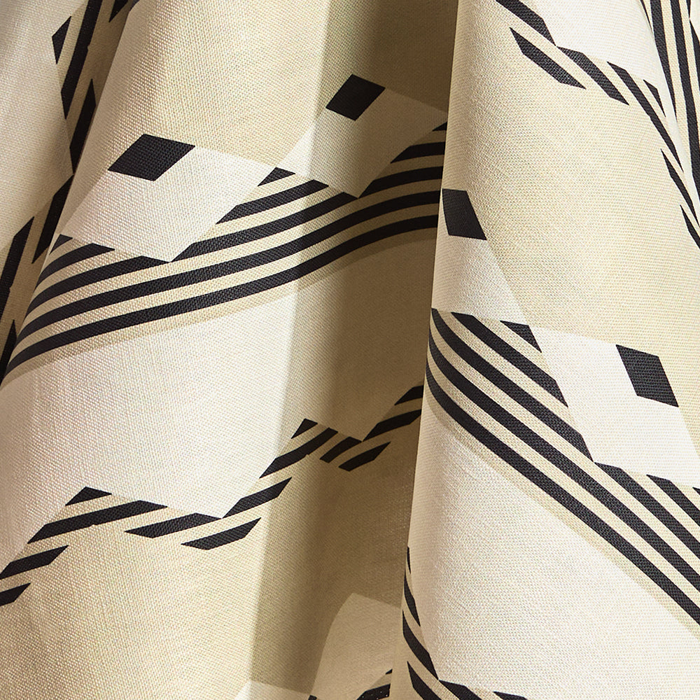Draped fabric in a graphic geometric design in ecru, cream and black. 