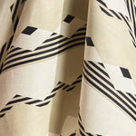Draped fabric in a graphic geometric design in ecru, cream and black. 