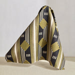 Hanging fabric piece in a graphic geometric design in sage green, taupe, white and black.