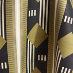 Draped fabric a graphic geometric design in sage green, taupe, white and black.