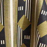 Draped fabric a graphic geometric design in sage green, taupe, white and black.