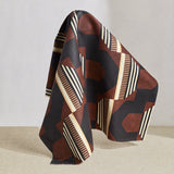 Draped fabric a graphic geometric design in burn siena, black, taupe and cream.