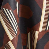 Draped fabric a graphic geometric design in burn siena, black, taupe and cream.