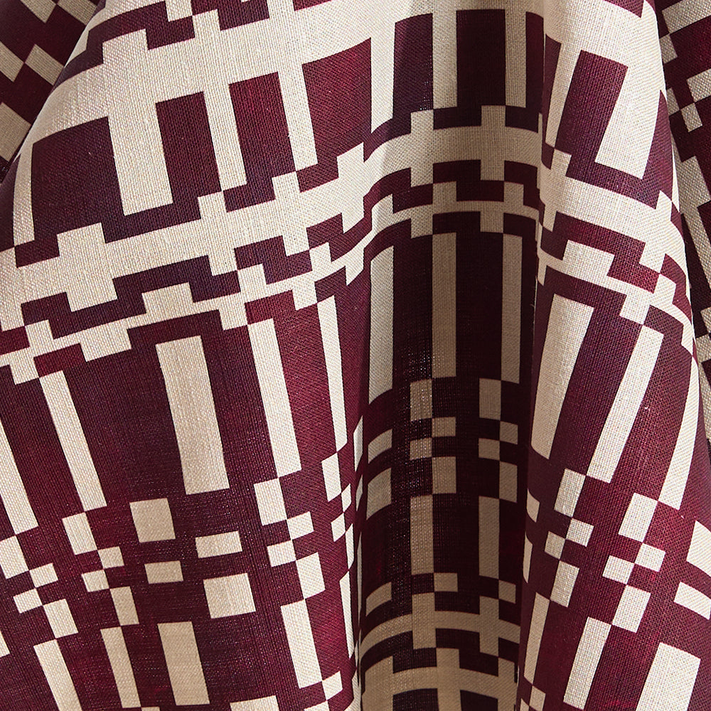 Printed linen in a modernist checkerboard pattern in maroon and cream.