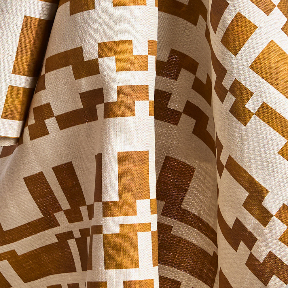 Printed fabric in a modernist checkerboard pattern in yellow ochre and cream.