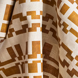 Printed fabric in a modernist checkerboard pattern in yellow ochre and cream.