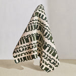 Draped fabric in a modernist checkerboard pattern in hunter green and cream.