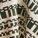 Fabric in a modernist checkerboard pattern in hunter green and cream.