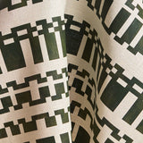 Fabric in a modernist checkerboard pattern in hunter green and cream.