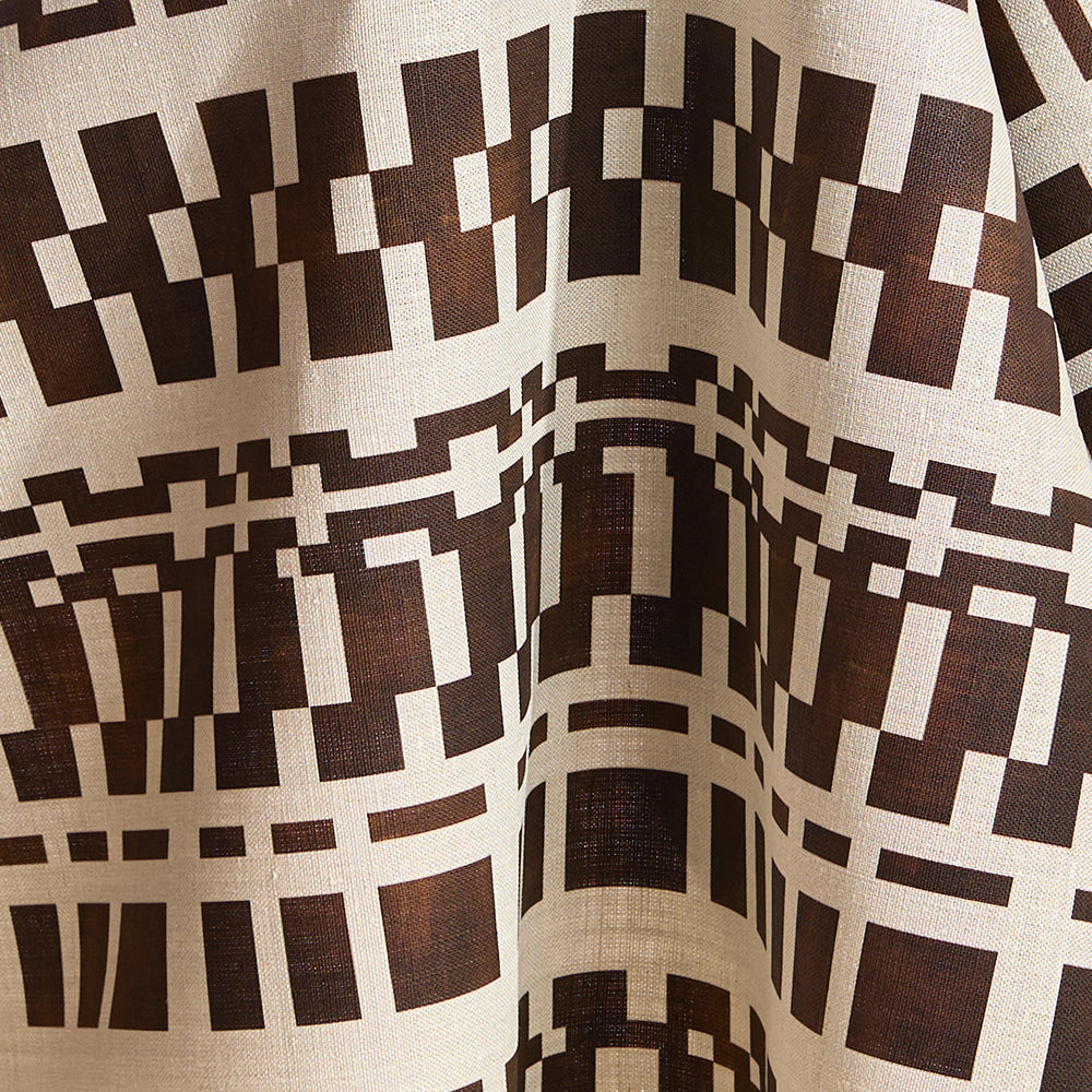 Draped fabric in a modernist checkerboard pattern in brown and cream.
