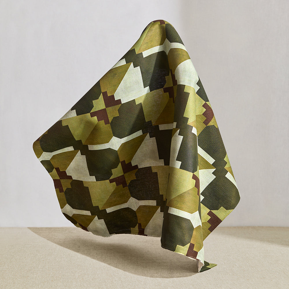 Hanging fabric in a bold abstract checkerboard pattern in brown, cream, sage and olive green.