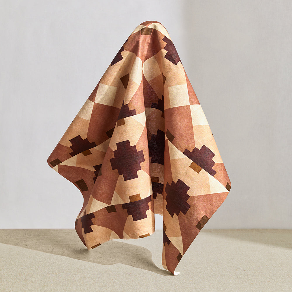Hanging fabric in a bold abstract checkerboard pattern in blush, oxblood, camel and cream.