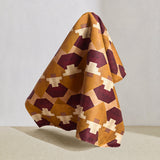 Hanging fabric in a bold abstract checkerboard pattern in blush, oxblood, camel and cream.