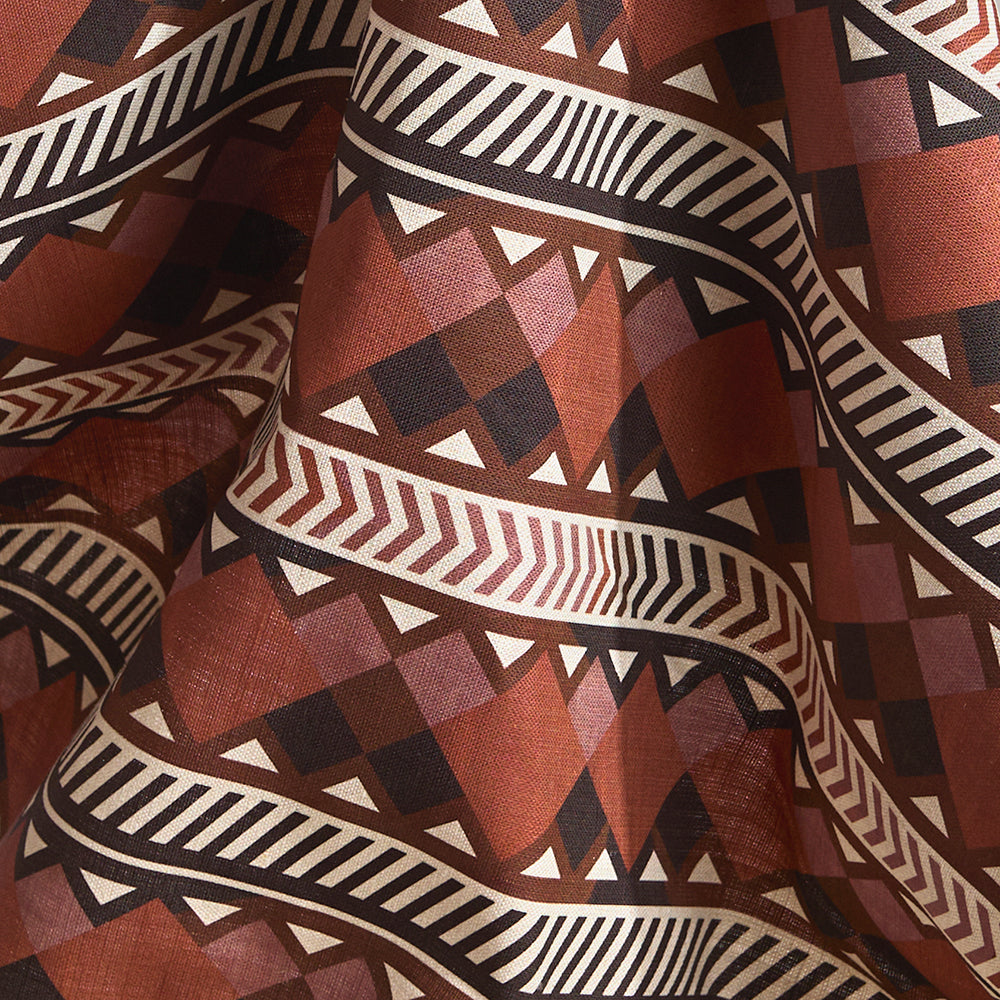 Fabric in a complex stripe with geometric shapes and chevrons in clay, lilac, brown and cream.