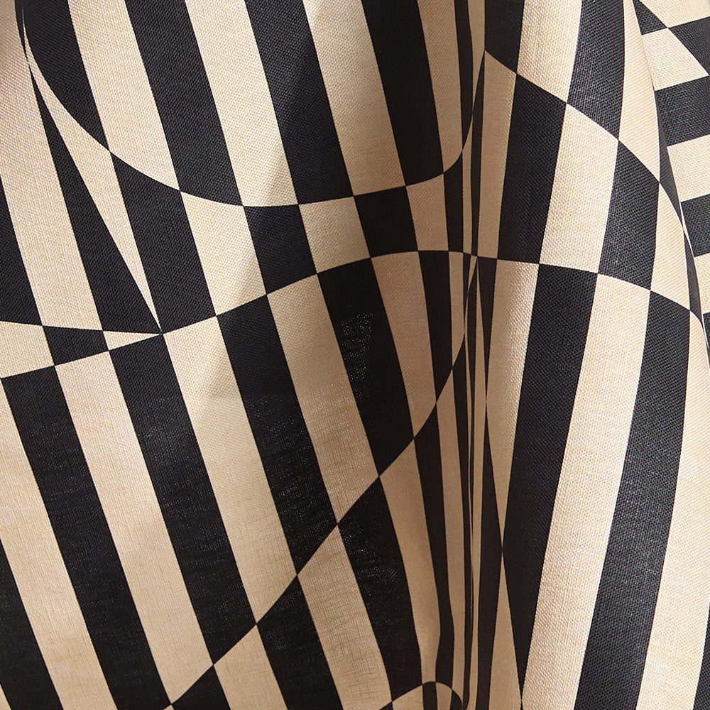 Draped fabric in a trompe l'oeil stripe pattern with geometric shapes in cream and black.