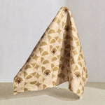 Hanging fabric in a curvilinear art deco inspired pattern in taupe, beige and brown.